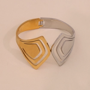 Detail view of two-tone gold and silver hollow geometric stainless steel bangle