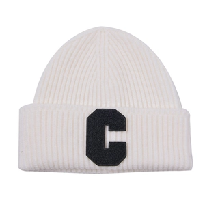 Detailed texture of off-white ribbed knit beanie with black terry embroidered letter C