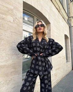 Outdoor street shot of women's two-piece set with geometric cat print and long sleeves