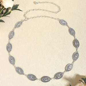 Detail of vintage bohemian silver waist chain with sunray texture and floral accents