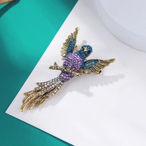Close-up of vintage gold eagle brooch with multi-color rhinestones and blue crystals