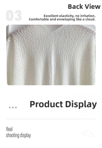 Detailed view of the hollow out knit pattern and soft texture on the back of the white shawl