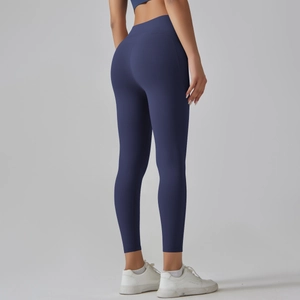 Macro detail of high-waist navy blue leggings showing smooth fabric and butt-lifting seam