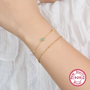 Detail of 925 sterling silver layered bracelet with turquoise and zircon stones