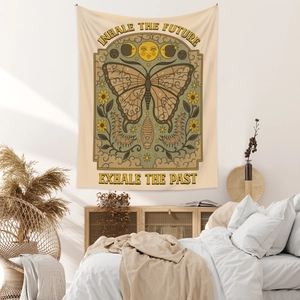 Bohemian butterfly tapestry with celestial sun and moon motifs in a cozy bedroom