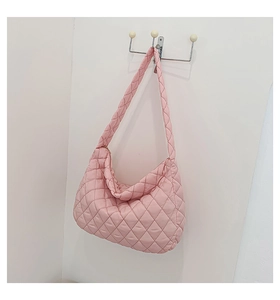 Close-up of pink quilted space cotton tote bag with soft padded diamond texture design