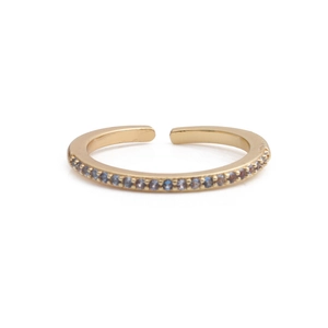Macro detail of gold-plated open ring with light blue and purple zircon pavé setting