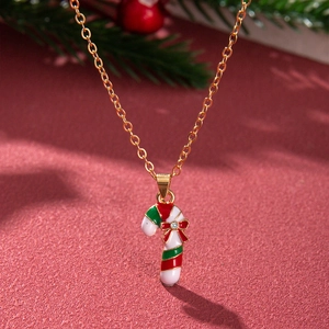 Close-up of gold Christmas candy cane necklace with red and green enamel and crystal