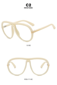 Dettaglio degli inserti a T in metallo dorato su montatura aviator oversize crema