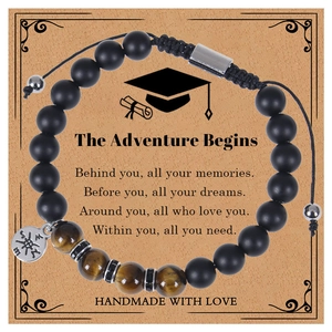 Detail of pink zebra stone compass bracelet with black beads on graduation gift card