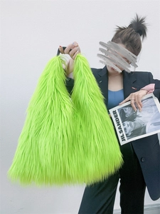 Neon green faux fur tote bag styled with black blazer for a trendy Y2K winter look