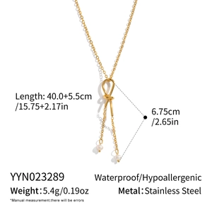 Detail of stainless steel knotted chain necklace featuring white freshwater pearls