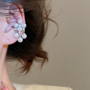 Close-up of pearl and zircon cluster ear cuff on ear with a minimalist style