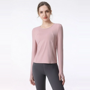 Women's dusty pink long sleeve yoga top with thumbholes and grey high waist leggings