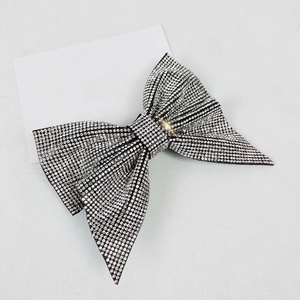 Detailed view of luxury white rhinestone bow hair clip with sparkling crystal inlay