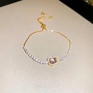 Elegant gold-tone bracelet with pink emerald-cut zircon and adjustable slider clasp
