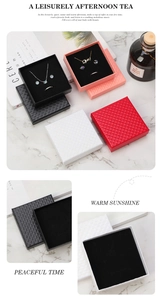 Detail of diamond textured jewelry gift boxes with plush lining on marble table