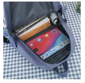 Detail view of the spacious inner compartments of the blue student canvas backpack