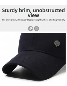 Detailed macro view of the curved brim and metal shield badge on a navy baseball cap