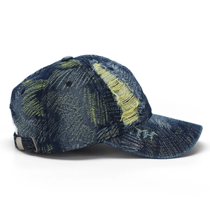 Close-up of distressed denim baseball cap with yellow contrast stitching and metal buckle