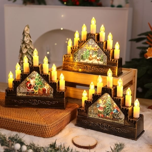 Macro shot of 7 and 9 LED candle lanterns featuring festive Santa and reindeer snow scenes