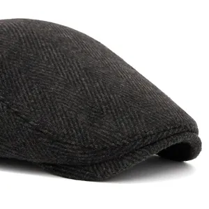 Men's dark gray herringbone flat cap with a foldable brim and warm knit texture