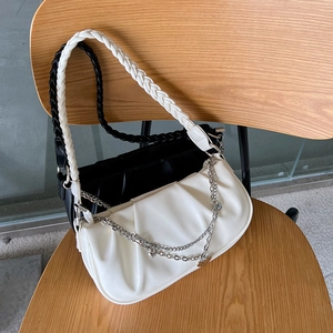 Detail of cloud shoulder bags in black and white leather with woven handle and chain