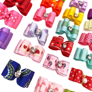 Colorful pet hair bows with rhinestones and assorted patterns for dogs and cats