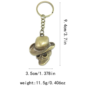 Detailed dimensions of vintage bronze skull keychain with hat, weighing 11.5g and 9.4cm long