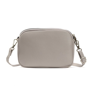 Minimalist grey grain leather crossbody camera bag with silver metal hardware and strap