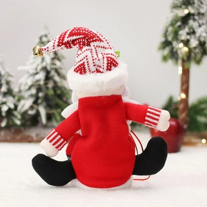 Plush Santa doll with red belt and knitted hat against a festive snowy background