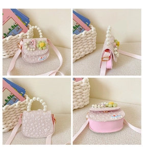 Detail view of pink kids crossbody bag with pearl handle and floral heart textures