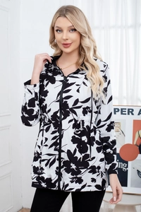 Detail of hooded zip jacket featuring black and white floral prints and drawstring waist