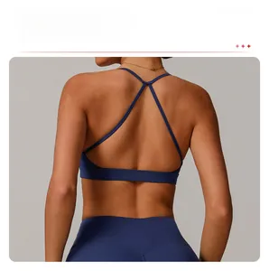 Detail view of the deep blue sports bra featuring an elegant cross back strap design
