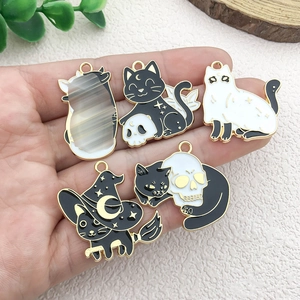 Set of five Halloween black and white enamel cat charms with gold metal edges for DIY jewelry
