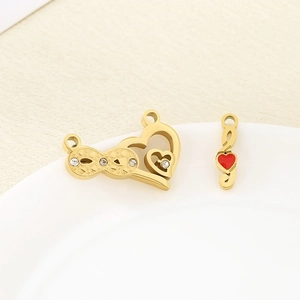 Close-up of gold stainless steel infinity heart and musical note charms with red detail