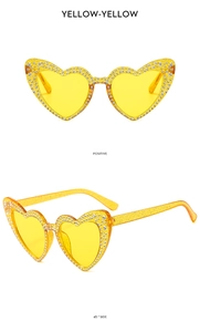 Macro detail of yellow glitter heart sunglasses with rhinestone trim in two view angles
