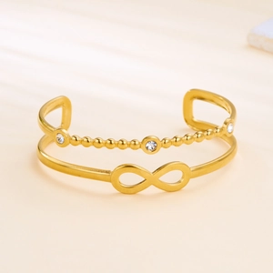 Detail of gold double-layer infinity bracelet with crystals and bead chain style