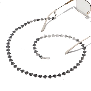 Stainless steel sunglasses chain featuring hollow heart links with rose pattern engraving