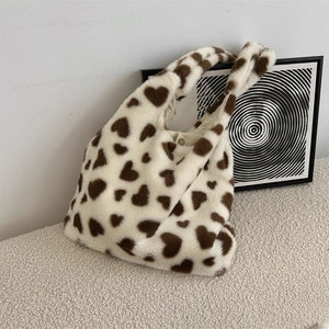 Close-up of the soft plush material and brown heart pattern on the large tote bag