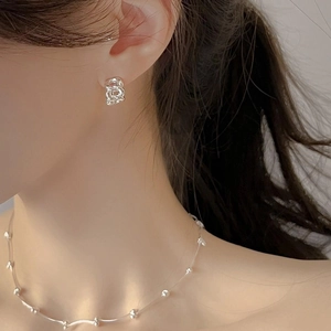 Elegant 925 sterling silver chain earrings and matching necklace worn by a fashion model