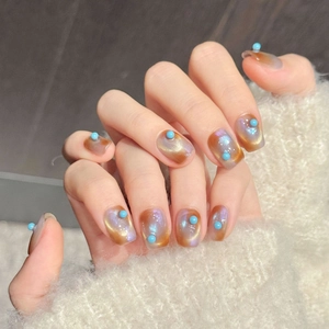 Handmade orange and blue cat-eye press-on nails with turquoise beads decoration