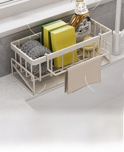 Kitchen sink organizer with a drip tray, holding sponges, towels and cleaning supplies