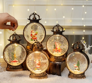 Close-up of vintage bronze Christmas lanterns with snow globe scenes and warm LED lighting