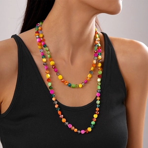 Detail showing colorful irregular faux shell beads and crystals on a layered necklace