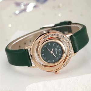 Detailed macro view of the rhinestone-set dial and green leather strap of the luxury watch