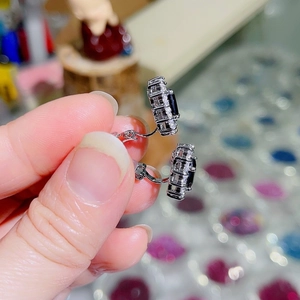 Detail of silver clip-on earrings with rectangular black stone and white zircon halo