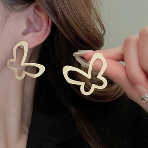 Minimalist matte gold hollow butterfly stud earrings with brushed metallic texture