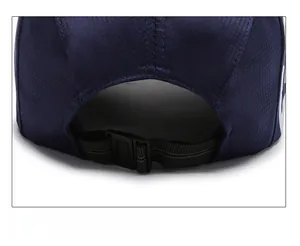 Detail of adjustable strap and plastic buckle on navy blue quick-dry baseball cap