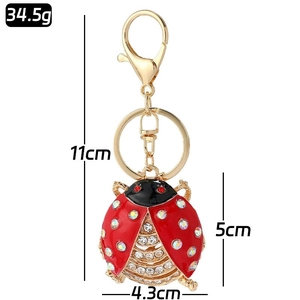 Detail view of ladybug keychain with red rhinestones and measurements 11x4.3cm